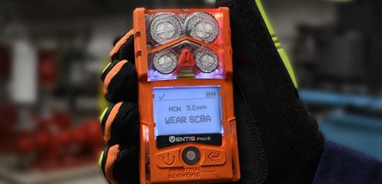close-up of gas monitor screen displaying HCN concentration 5.0ppm and message "wear SCBA"