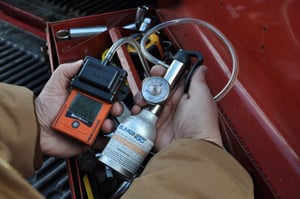 worker bump testing orange personal gas monitor with calibration gas