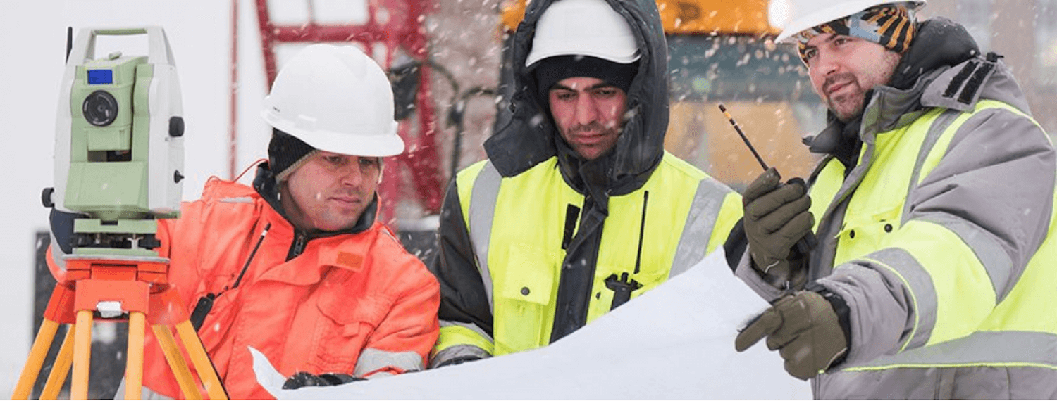 three workers in the snow