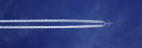 bottom-view-of-plane-with-contrail-1436697