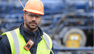 man wearing personal protective equipment and a personal gas detector with LEL sensor on his collar looks forward Featured Image
