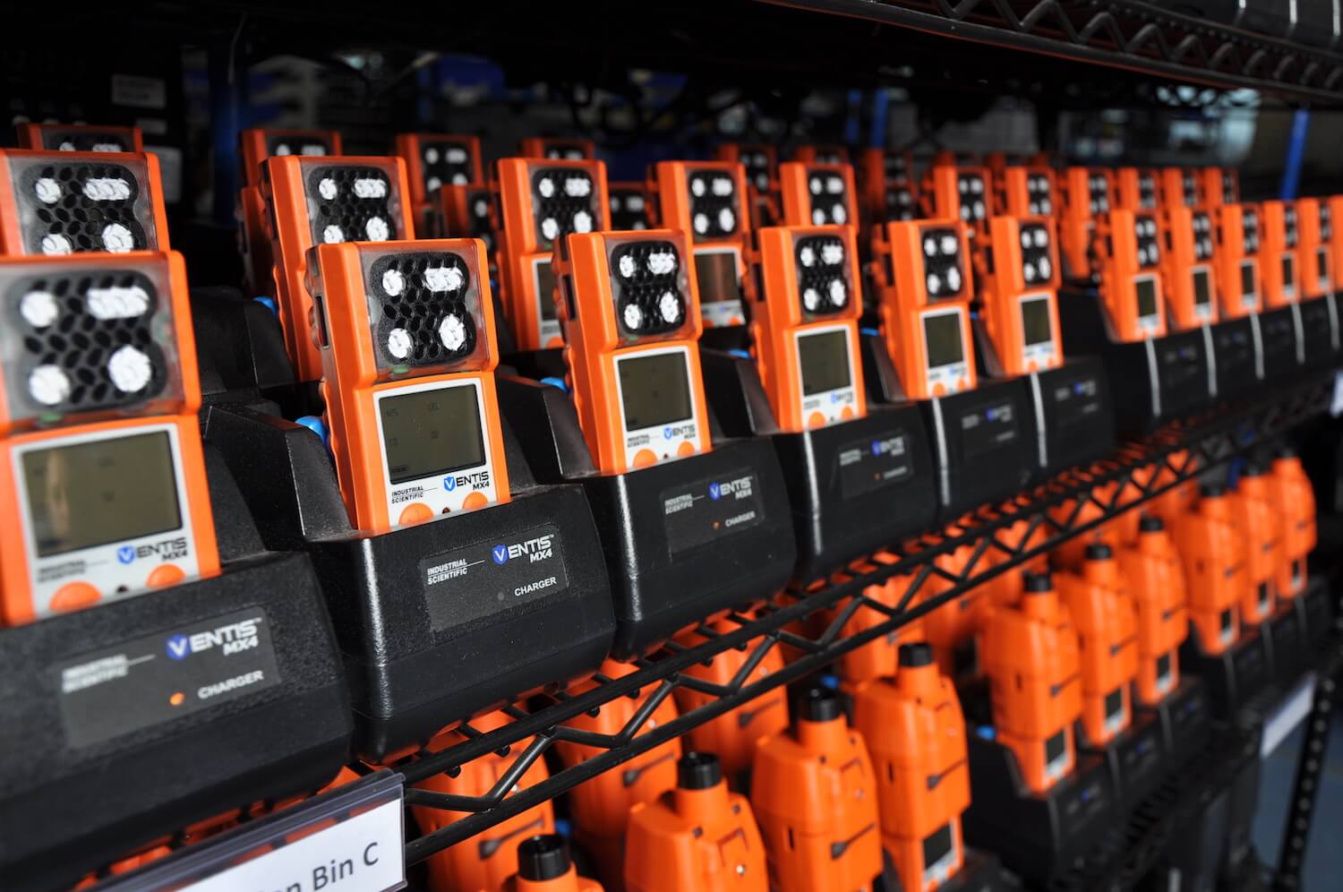 Shelves filled with multiple rows of personal gas monitors.