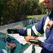 Picture of a worked using sampling tubing with a confined space monitor