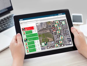 close shot of someone holding a tablet with an iNet Now dashboard that shows a worker with a high gas alert and location on a map