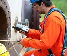 Picture of worker using a confined space monitor and probe to test a confined space