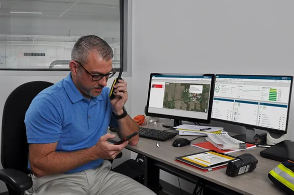 safety manager sits in his office and uses iNet Now live monitoring to monitor lone worker safety